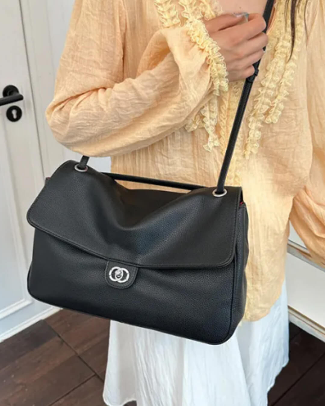Solveig Buckle Flap Shoulder Bag in black – styled look